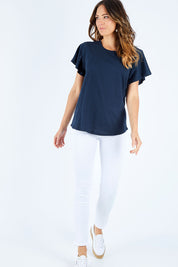 Model Madeline wearing size 10 of the Lucy Flutter Tee in colour Navy (Blue), from the front, showing the whole outfit