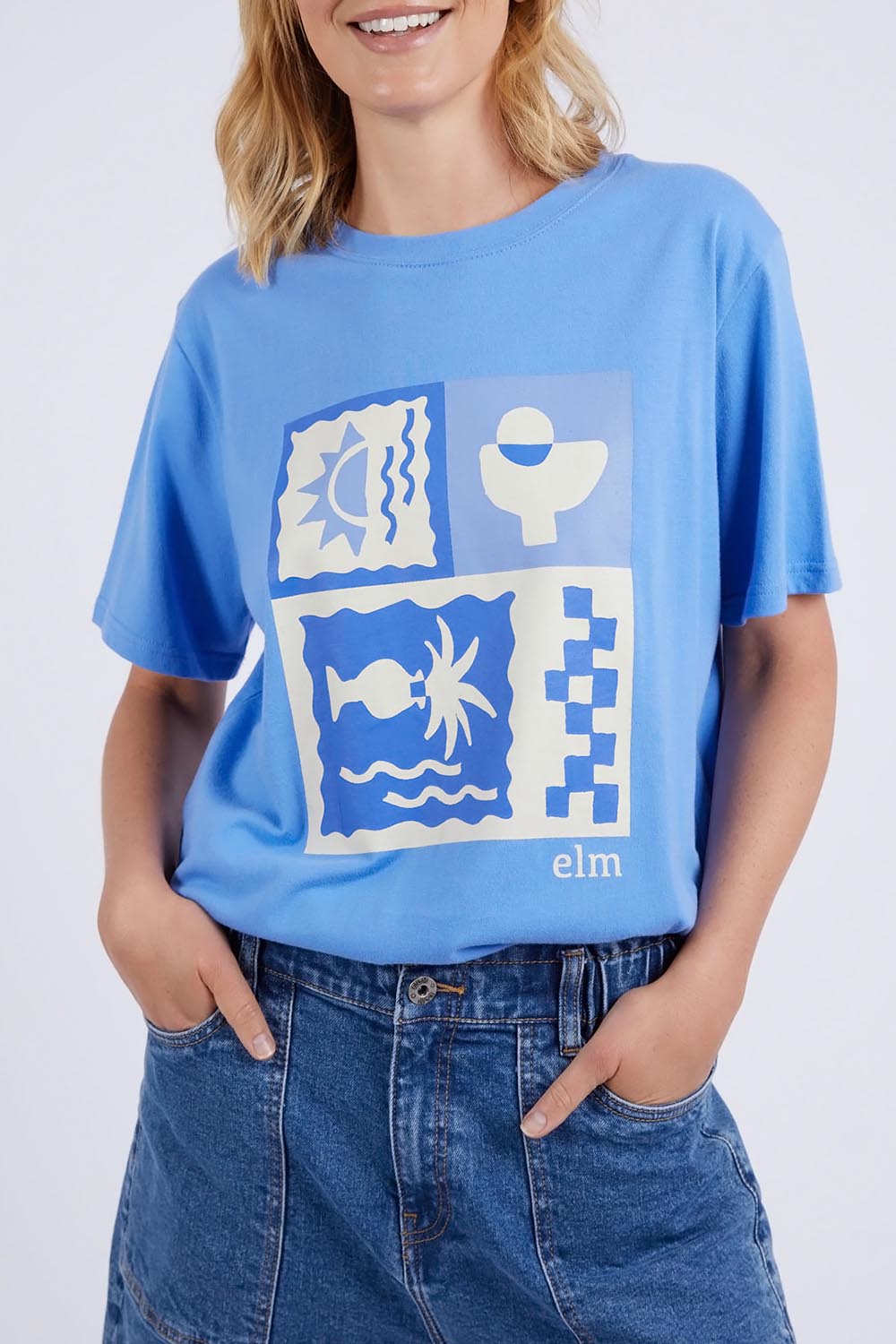 A model wearing the Holiday Sun Tee in colour Cerulean (Blue), from the front, cropped image