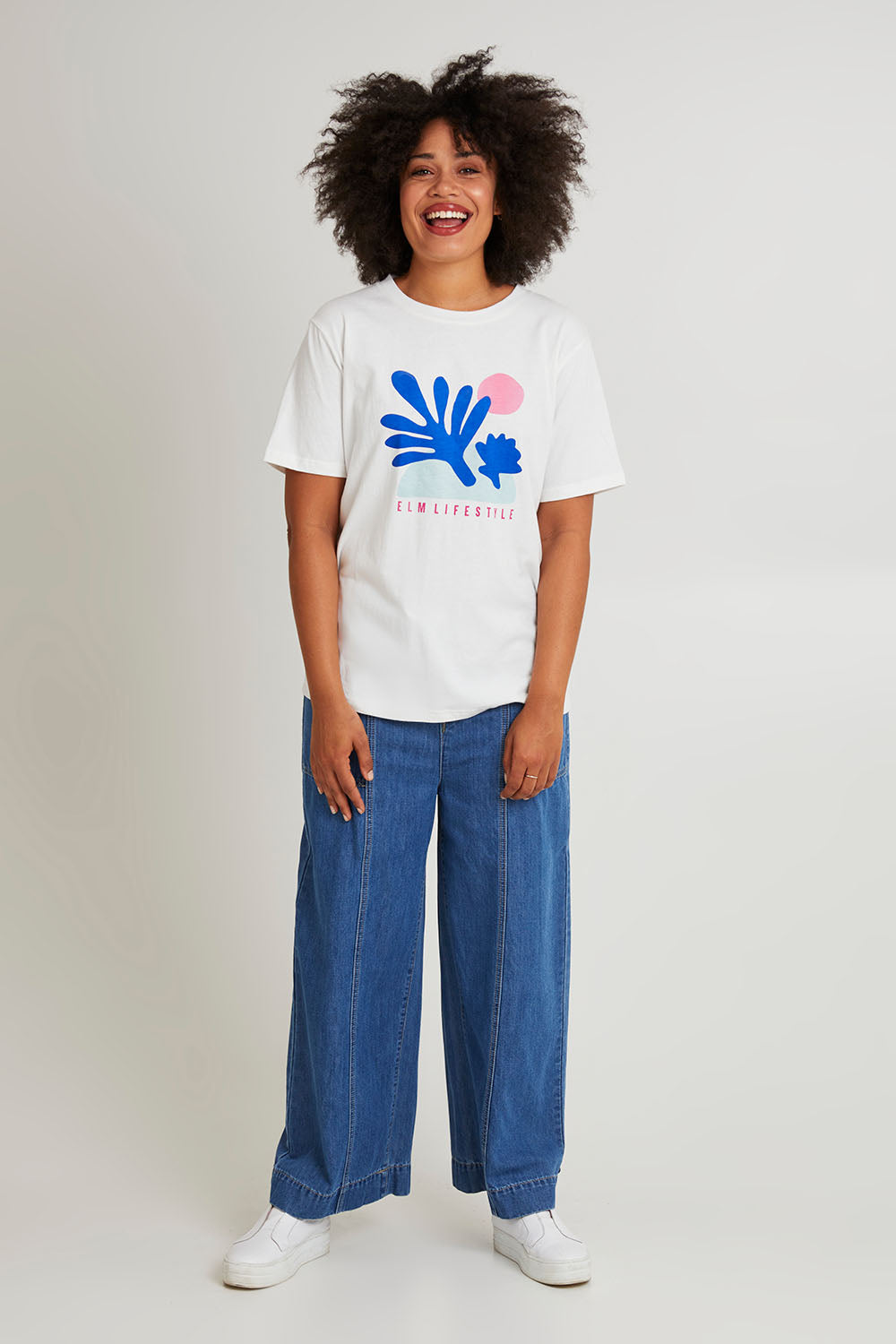 Model Olivia wearing size 10 of the Art House Cotton Tee in colour Marshmello (White), from the front, showing the whole outfit