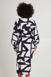 Model Olivia wearing size 10 of the Dali Abstract Dress in colour Midnight (Blue), from the back