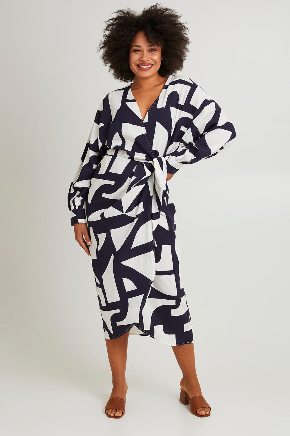 Model Olivia wearing size 10 of the Dali Abstract Dress in colour Midnight (Blue), from the front, showing the whole outfit