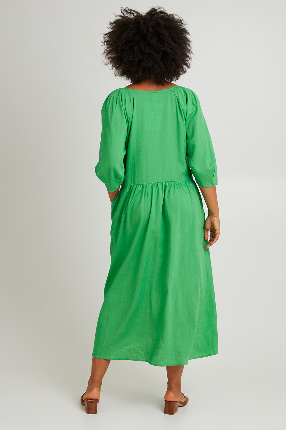 Model Olivia wearing size 10 of the Rosalie Dress in colour Greenbriar (Green), from the back