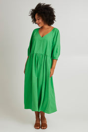 Model Olivia wearing size 10 of the Rosalie Dress in colour Greenbriar (Green), from the front, showing the whole outfit