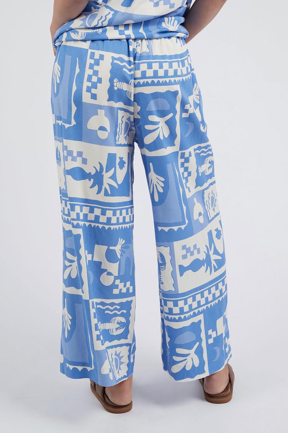 A model wearing the Holiday Sun Pant in colour Cerulean (Blue), from the back