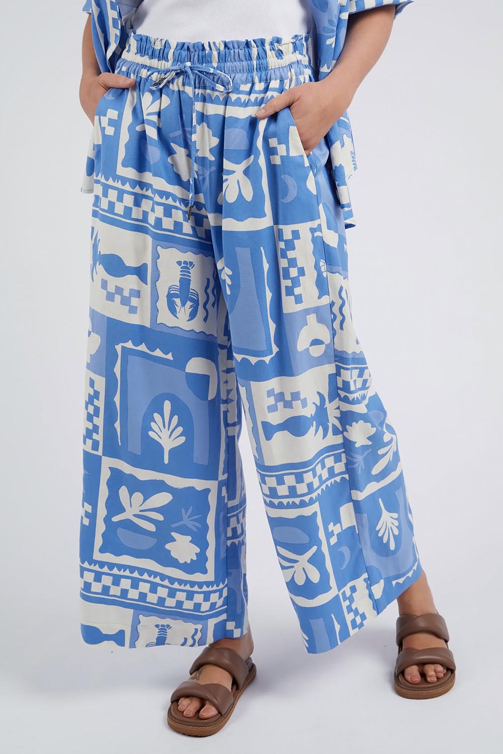 A model wearing the Holiday Sun Pant in colour Cerulean (Blue), from the front, cropped image