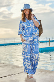 Model Katie wearing size 10 of the Holiday Sun Pant in colour Cerulean (Blue), from the front, showing the whole outfit