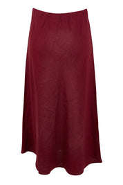 Product shot of the Eleni Linen Skirt in colour Plum (Red), from the back