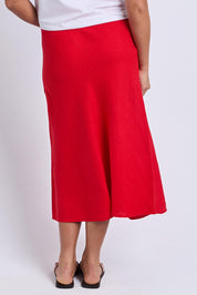 A model wearing the Eleni Linen Skirt in colour Poppy (Red), from the back
