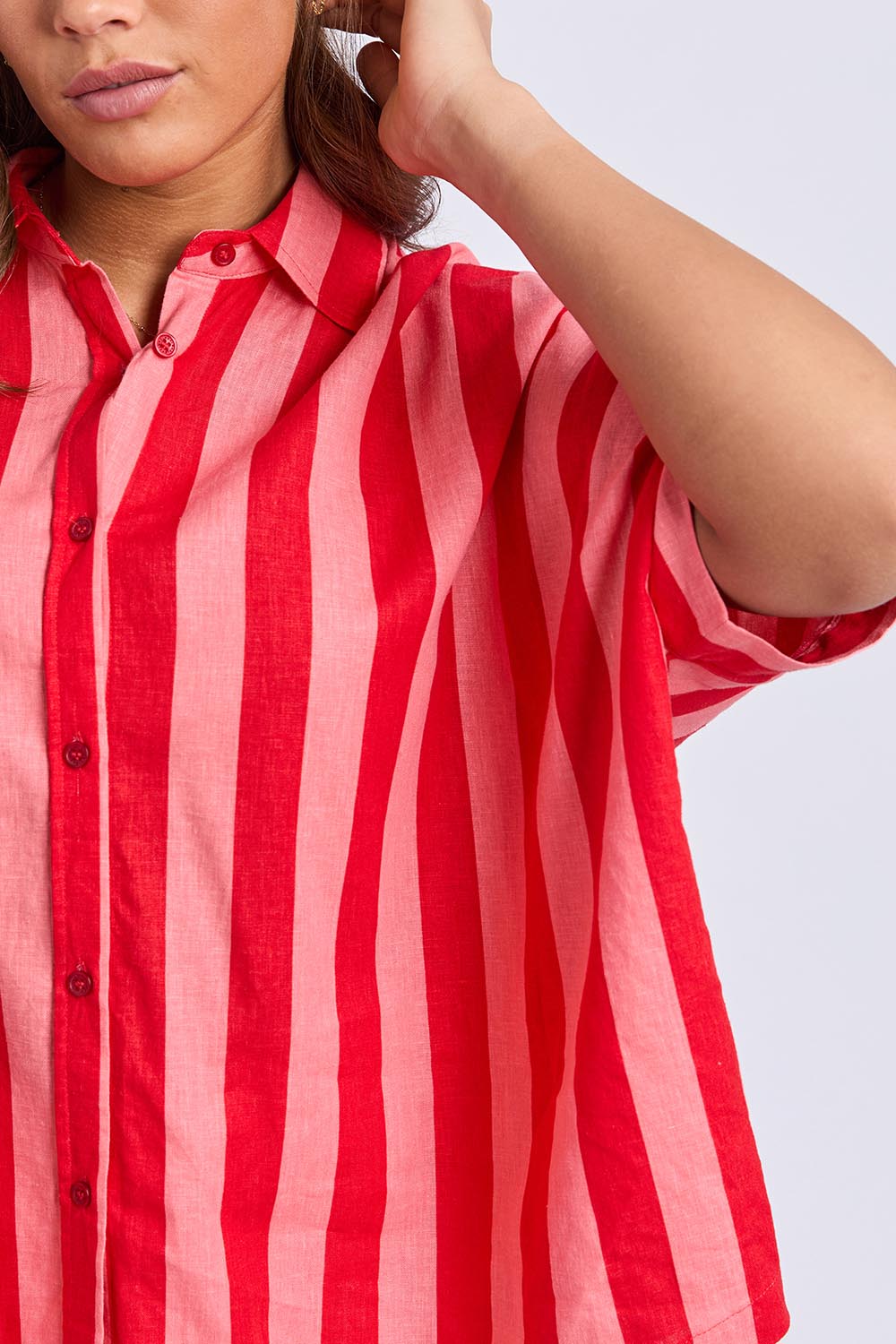 A model wearing the Palermo Linen Blend Stripe Shirt in colour Poppy, from the front, cropped image