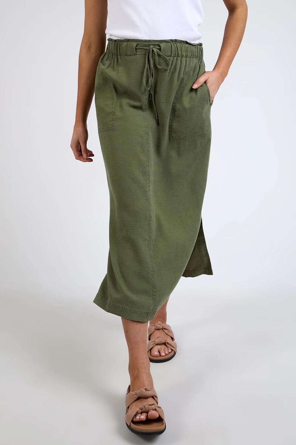 A model wearing the Mila Utility Skirt in colour Clover (Green), from the front, cropped image