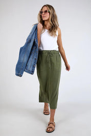 A model wearing the Mila Utility Skirt in colour Clover (Green), from the front, showing the whole outfit
