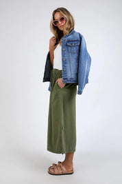 A model wearing the Mila Utility Skirt in colour Clover (Green), from the front, showing the whole outfit