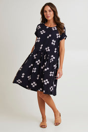 Model Madeline wearing size 10 of the Positano Linen Blend Dress in colour Navyprint (Blue), from the front, showing the whole outfit