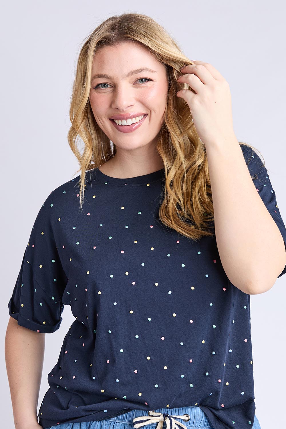 A model wearing the Festive Spot Cotton Blend Tee in colour Navy (Blue), from the front, cropped image