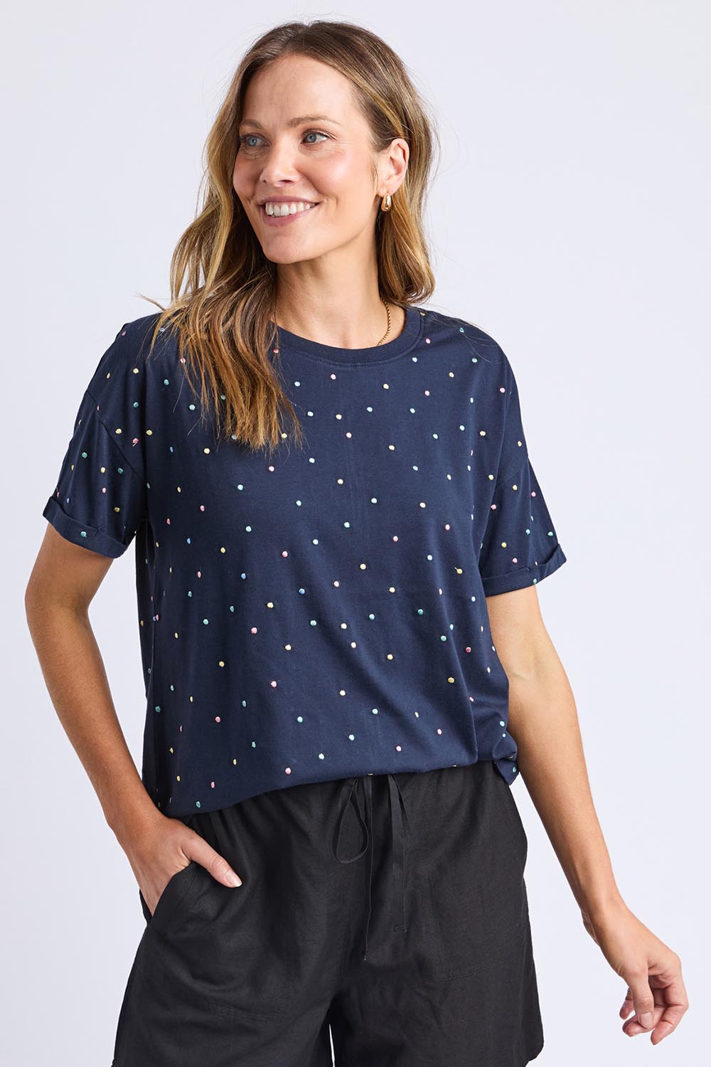 A model wearing the Festive Spot Cotton Blend Tee in colour Navy (Blue), from the front, cropped image