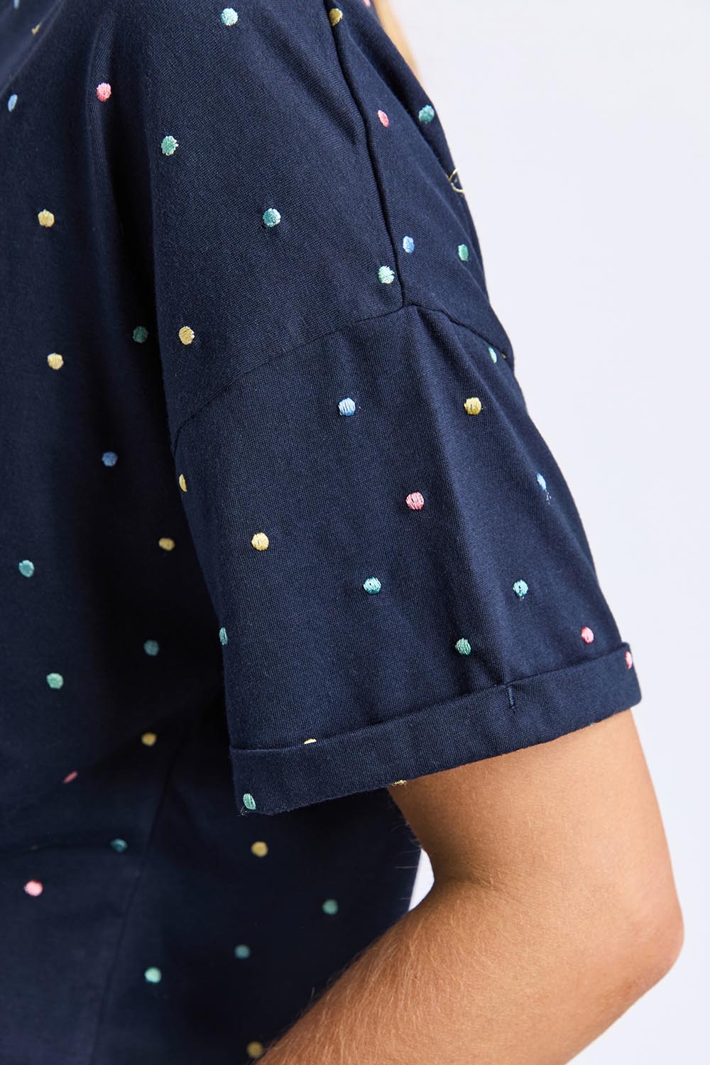 A model wearing the Festive Spot Cotton Blend Tee in colour Navy (Blue), from the front, cropped image
