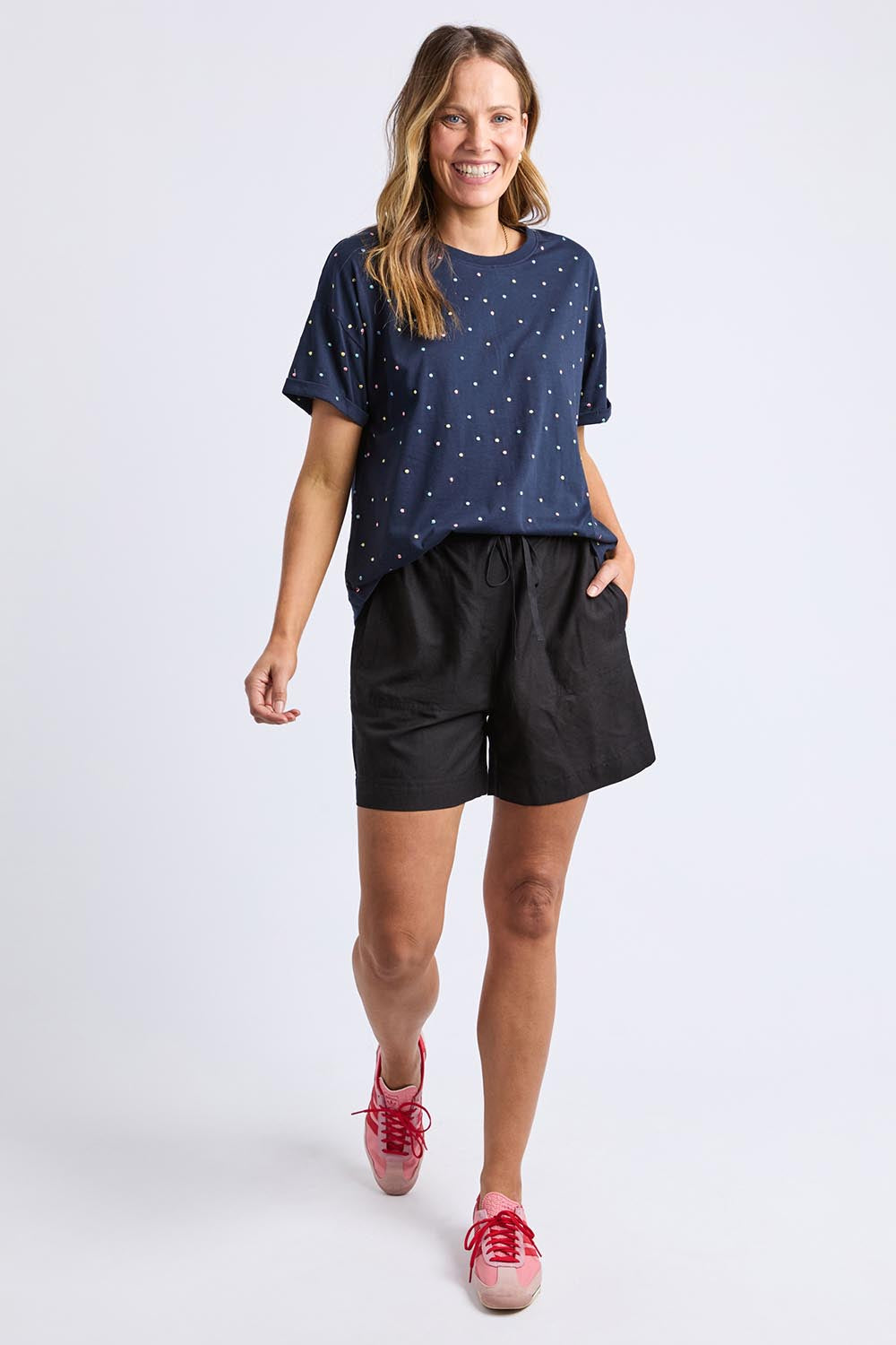 A model wearing the Festive Spot Cotton Blend Tee in colour Navy (Blue), from the front, showing the whole outfit