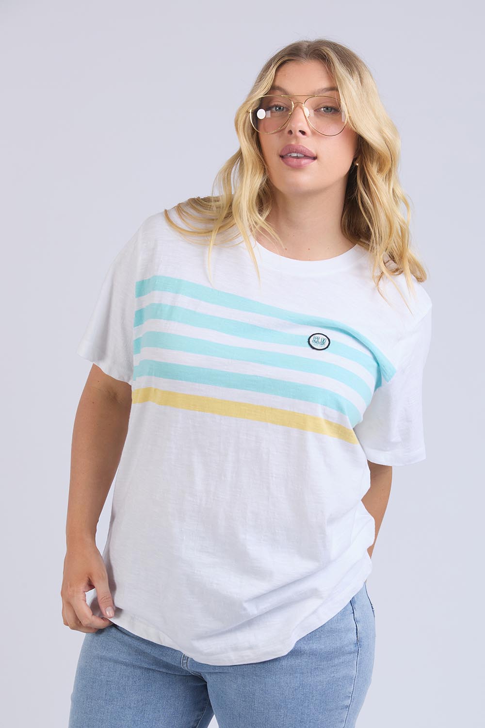 A model wearing the Line Up Tee in colour Marshmello (White), from the front, cropped image