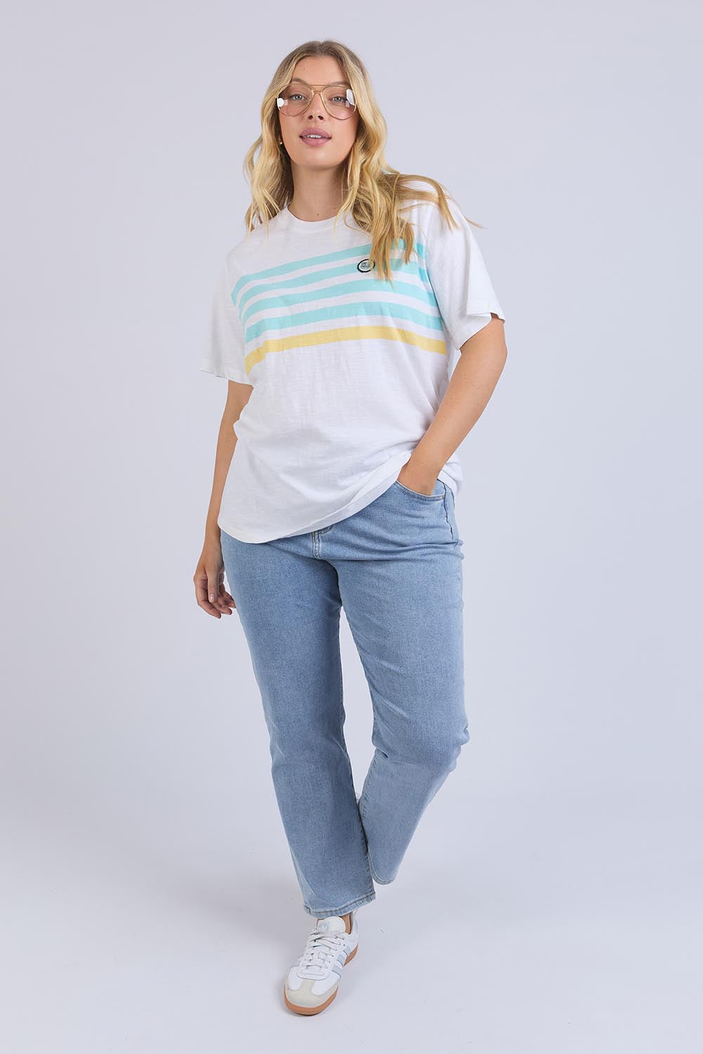A model wearing the Line Up Tee in colour Marshmello (White), from the front, showing the whole outfit