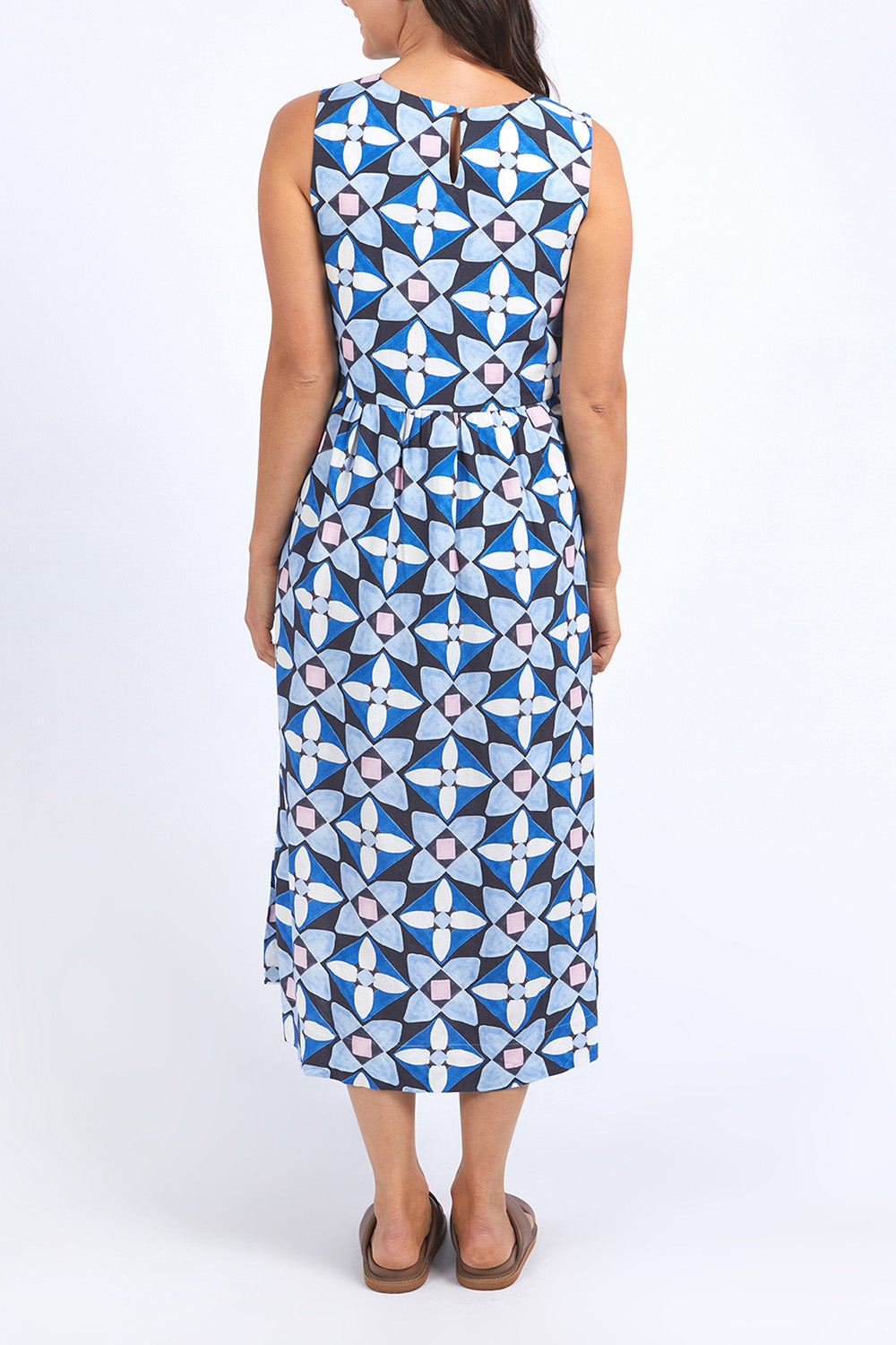 A model wearing the Painted Tile Linen Blend Dress in colour Geoprint (Blue), from the back