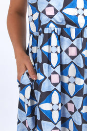 A model wearing the Painted Tile Linen Blend Dress in colour Geoprint (Blue), from the front, cropped image