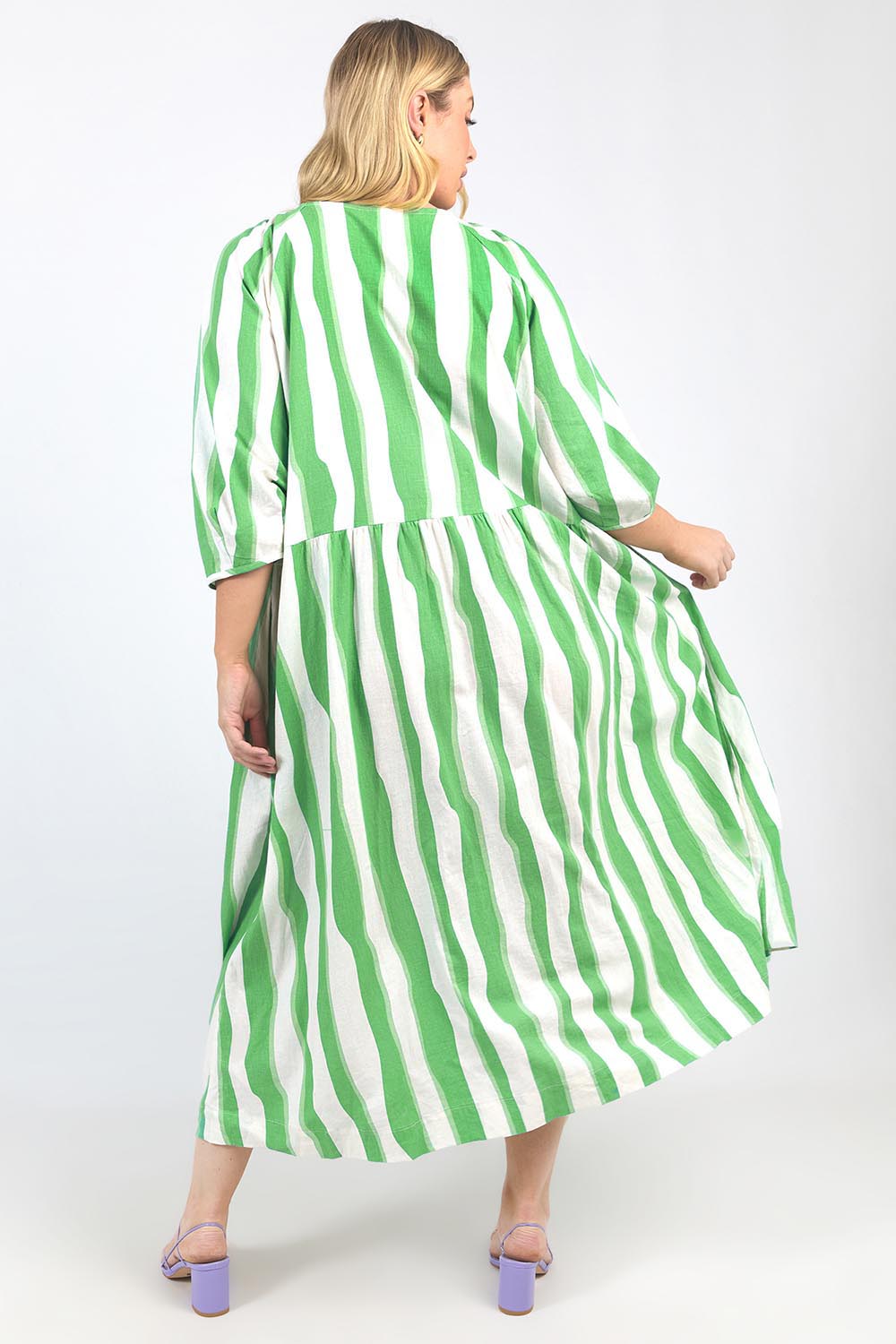 A model wearing the Spritz Stripe Linen Blend Dress in colour Greenwhite (Green), from the back