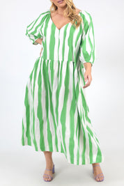 A model wearing the Spritz Stripe Linen Blend Dress in colour Greenwhite (Green), from the front, cropped image