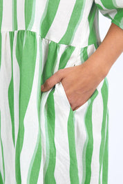A model wearing the Spritz Stripe Linen Blend Dress in colour Greenwhite (Green), from the front, cropped image