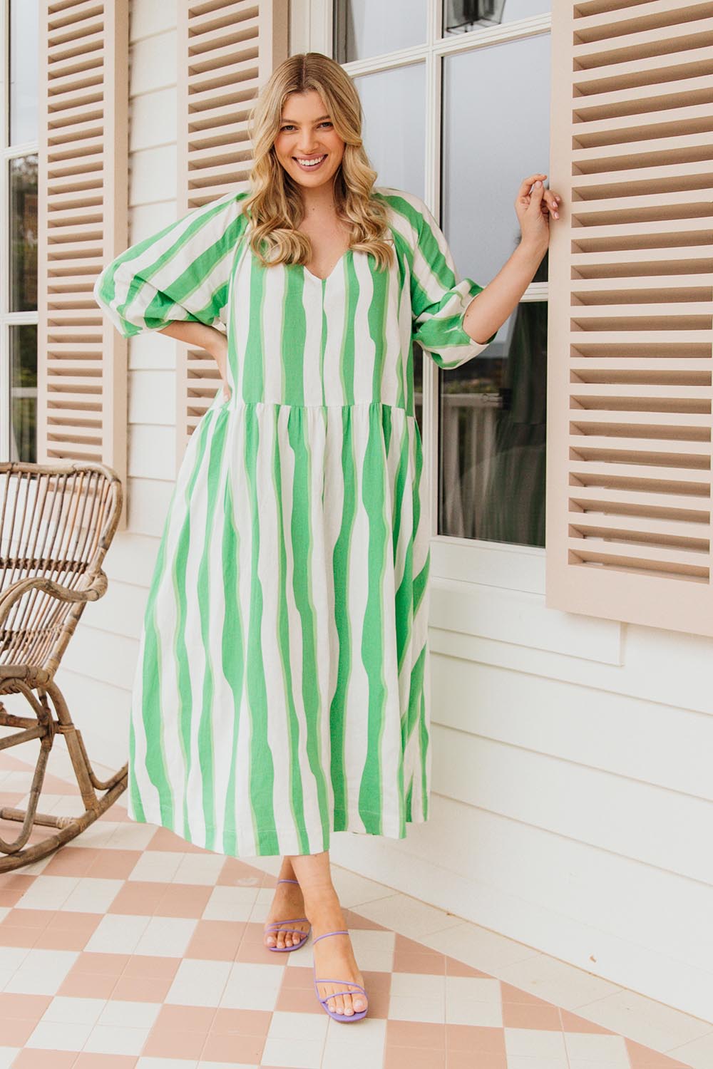 A model wearing the Spritz Stripe Linen Blend Dress in colour Greenwhite (Green), from the front, showing the whole outfit