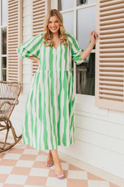 A model wearing the Spritz Stripe Linen Blend Dress in colour Greenwhite (Green), from the front, showing the whole outfit