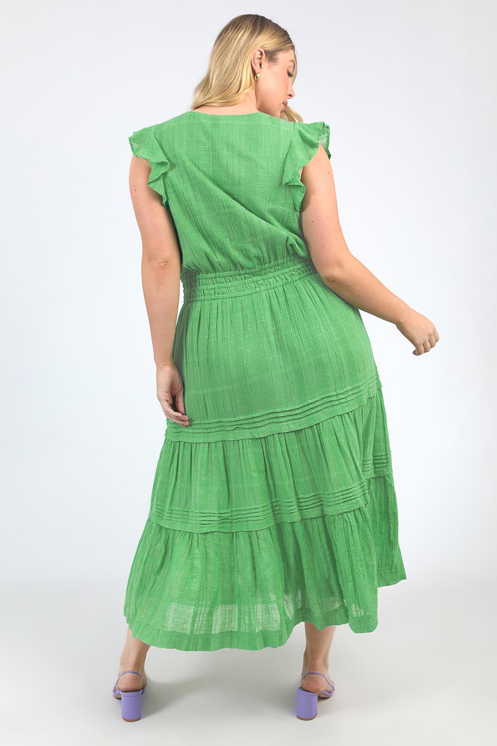 A model wearing the Isabella Cotton Blend Dress in colour Greenbriar (Green), from the back