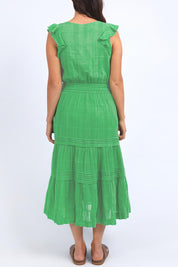 A model wearing the Isabella Cotton Blend Dress in colour Greenbriar (Green), from the back