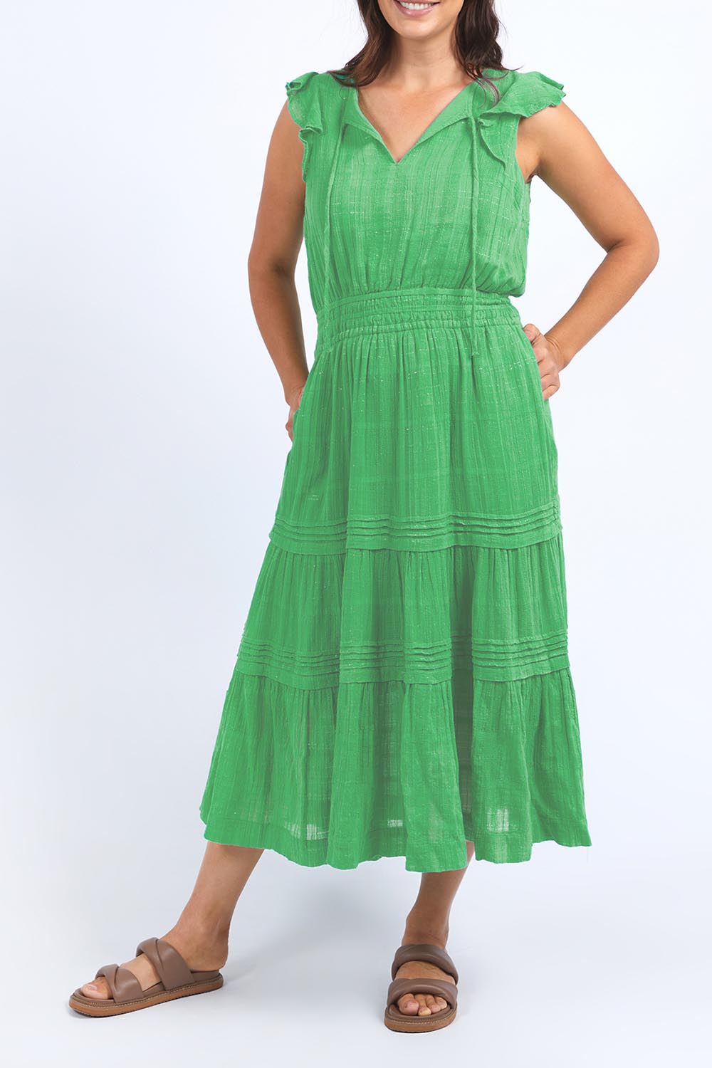 A model wearing the Isabella Cotton Blend Dress in colour Greenbriar (Green), from the front, cropped image