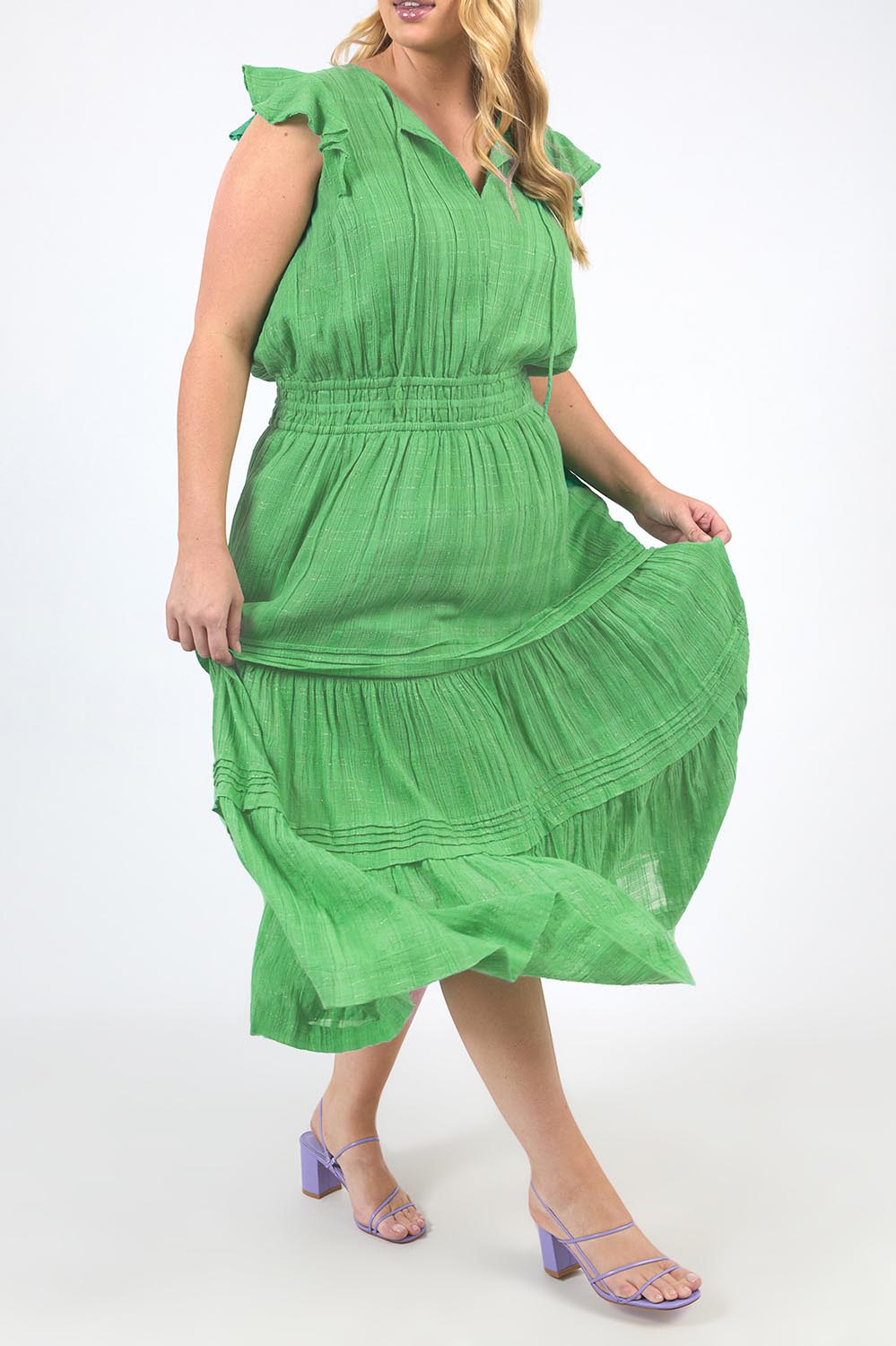 A model wearing the Isabella Cotton Blend Dress in colour Greenbriar (Green), from the front, cropped image