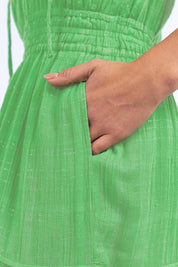 A model wearing the Isabella Cotton Blend Dress in colour Greenbriar (Green), from the front, cropped image