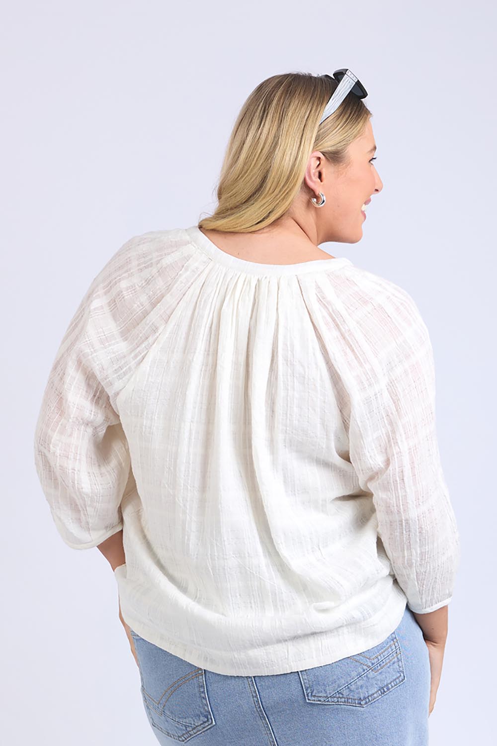 A model wearing the Isabella Cotton Blend Blouse in colour Marshmello, from the back