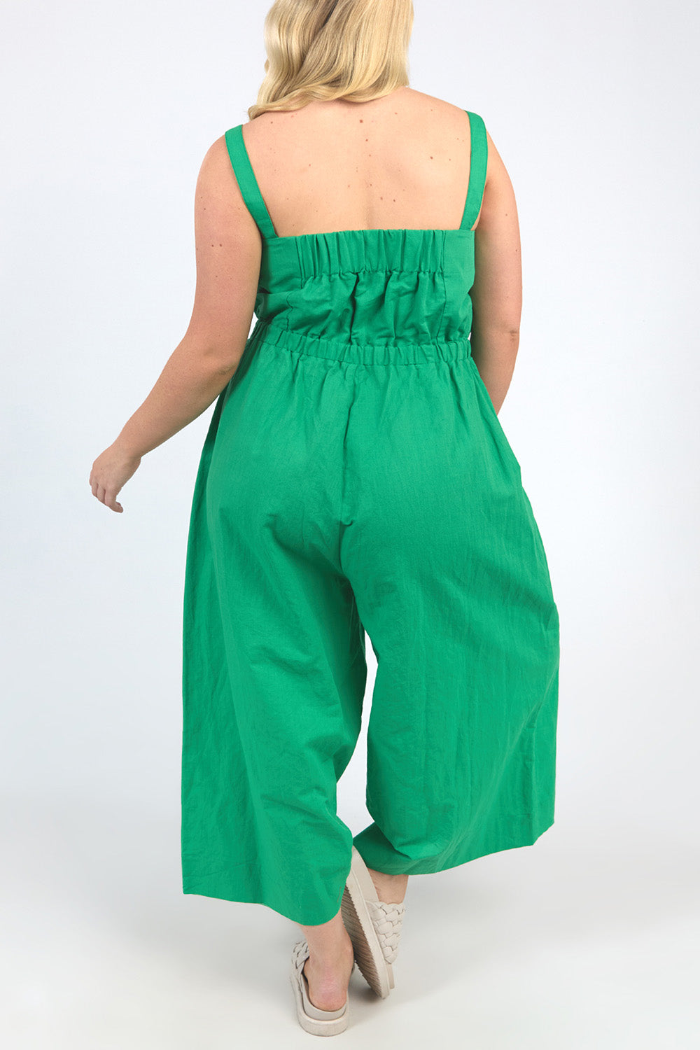 A model wearing the Stevie Jumpsuit in colour Greenbriar (Green), from the back