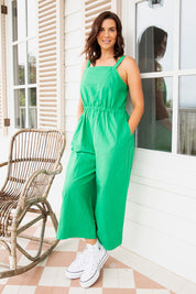 A model wearing the Stevie Jumpsuit in colour Greenbriar (Green), from the front, showing the whole outfit