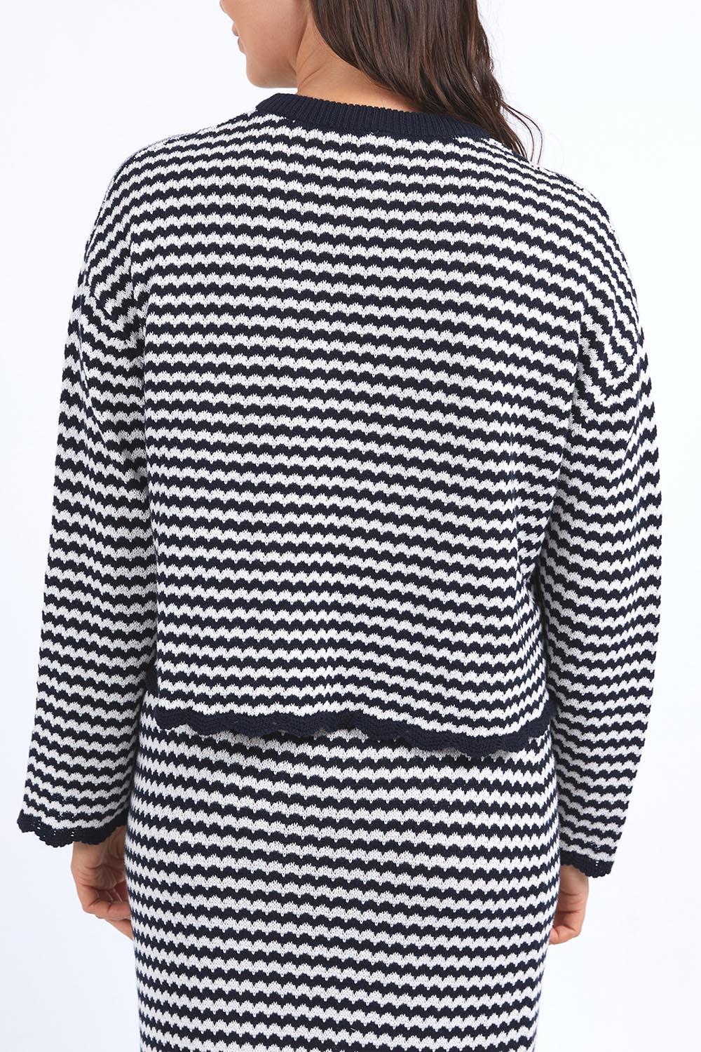 A model wearing the Rosie Stripe Cotton Knit Top in colour Navywhite, from the back