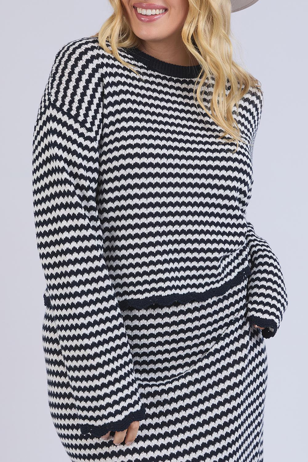 A model wearing the Rosie Stripe Cotton Knit Top in colour Navywhite, from the front, cropped image