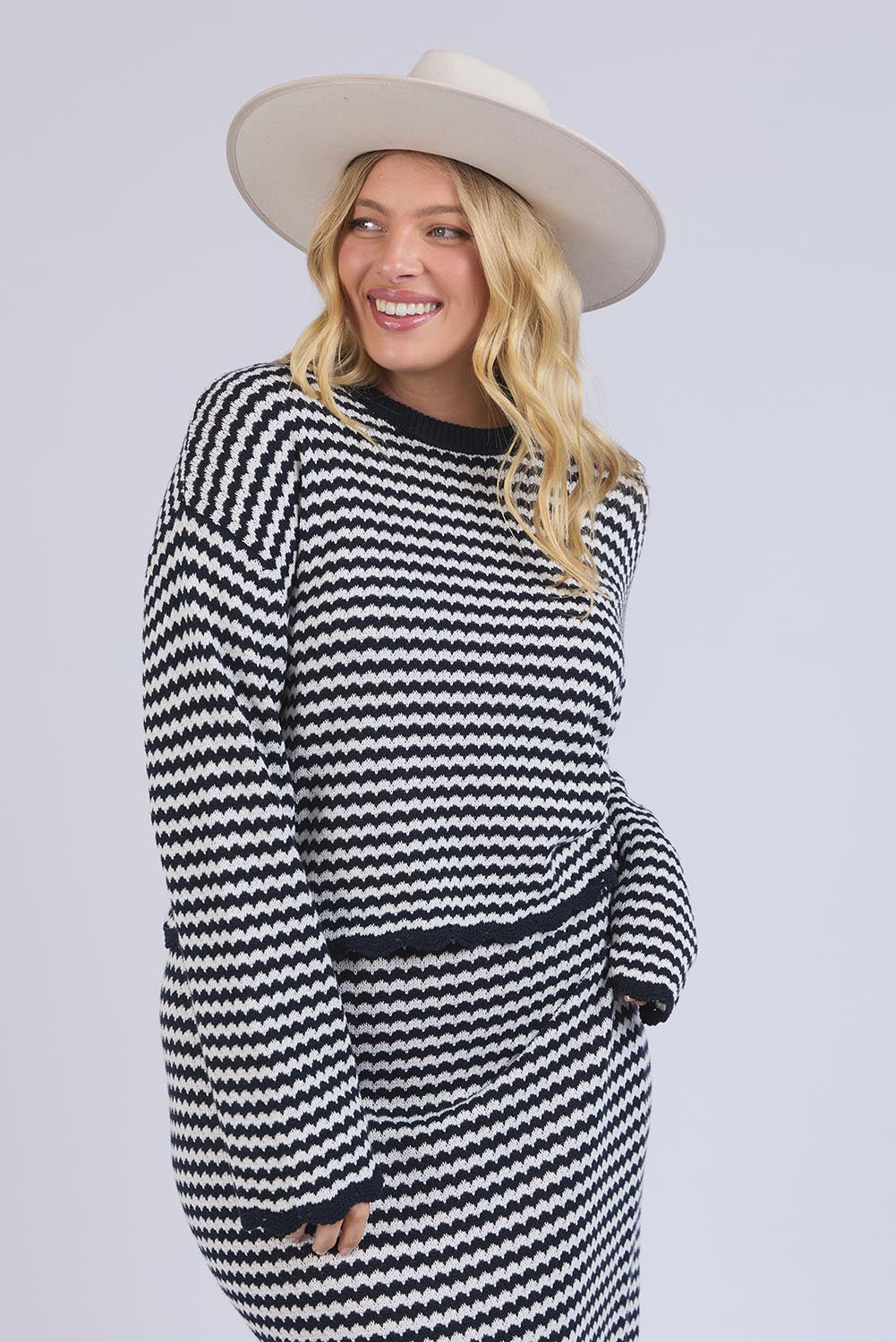 A model wearing the Rosie Stripe Cotton Knit Top in colour Navywhite, from the front, cropped image