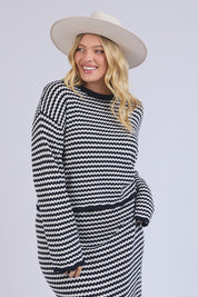 A model wearing the Rosie Stripe Cotton Knit Top in colour Navywhite, from the front, cropped image