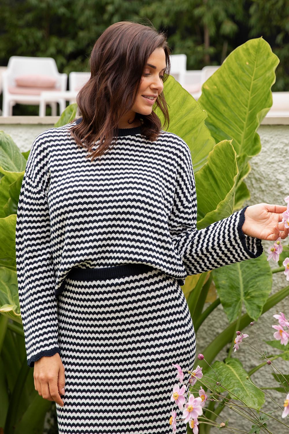 A model wearing the Rosie Stripe Cotton Knit Top in colour Navywhite, from the front, showing the whole outfit
