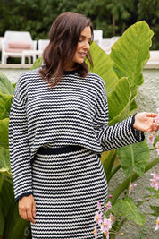 A model wearing the Rosie Stripe Cotton Knit Top in colour Navywhite, from the front, showing the whole outfit