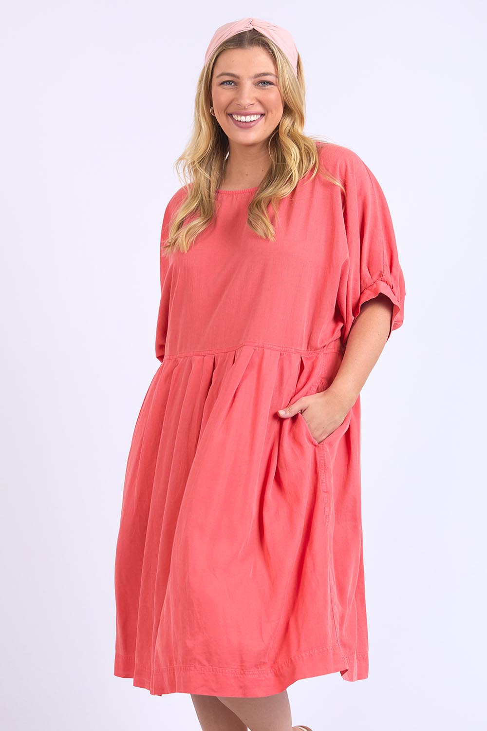 A model wearing the Bliss Relaxed Lyocell Linen Dress in colour Watermelon (Pink), from the front, cropped image