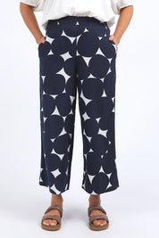 A model wearing the Demi Spot Lyocell Linen Pant in colour Spotprint (Blue), from the front, cropped image