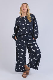 A model wearing the Demi Spot Lyocell Linen Pant in colour Spotprint (Blue), from the front, showing the whole outfit