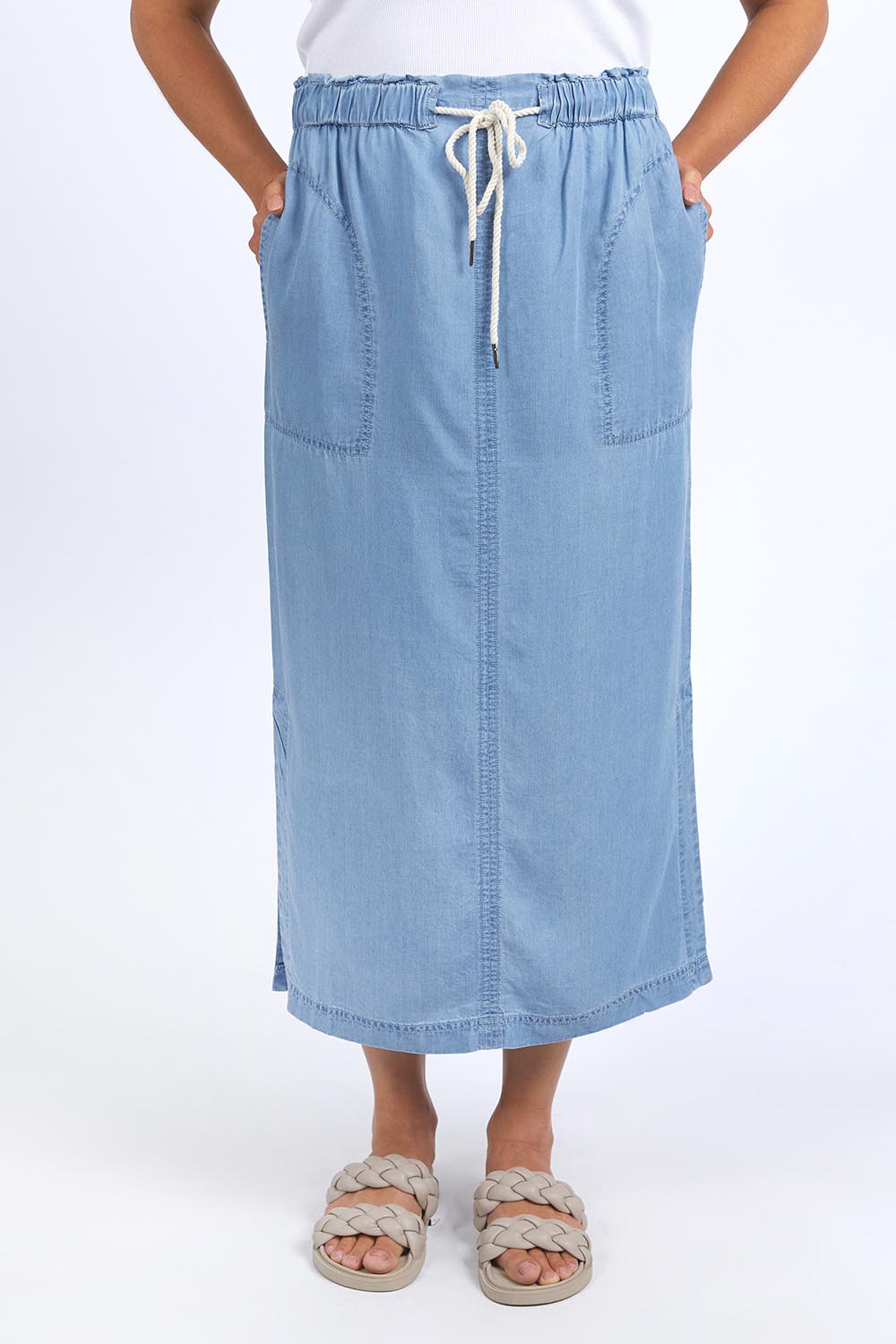 A model wearing the Penny Chambray Utility Skirt in colour Midblue (Blue), from the front, cropped image