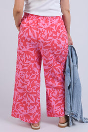 A model wearing the Sunset Hour Linen Blend Pant in colour Sunset (Pink), from the back