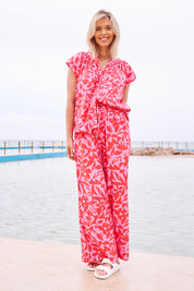 Model Phoebe wearing size 10 of the Sunset Hour Linen Blend Pant in colour Sunset (Pink), from the front, showing the whole outfit